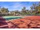 Active lifestyle awaits with well-maintained tennis courts surrounded by lush greenery at 1529 Oak Way, Sarasota, FL 34232