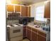 Galley kitchen with wood cabinets and appliances at 2175 Conway Blvd, Port Charlotte, FL 33952