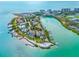Stunning aerial view of waterfront property featuring lush landscaping, boat docks and turquoise waters at 225 Sands Point Rd # 6204, Longboat Key, FL 34228