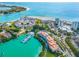 Breathtaking aerial view showcasing beachfront condos, boat docks, and pristine turquoise waters at 225 Sands Point Rd # 6204, Longboat Key, FL 34228