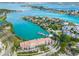 Aerial view of waterfront homes with boat docks and stunning turquoise waters surrounding the lush community at 225 Sands Point Rd # 6204, Longboat Key, FL 34228