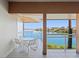 Enjoy the waterfront scenery from the balcony, featuring comfortable seating and stunning water views at 225 Sands Point Rd # 6204, Longboat Key, FL 34228