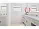 Bright bathroom featuring dual vanities and modern fixtures, for spa-like experience at 225 Sands Point Rd # 6204, Longboat Key, FL 34228