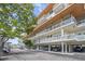 Luxury condo building exterior with parking, beautiful landscaping, and glass balconies at 225 Sands Point Rd # 6204, Longboat Key, FL 34228
