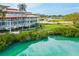 Beautiful exterior view of a modern building with lush landscaping, set along a waterfront community at 225 Sands Point Rd # 6204, Longboat Key, FL 34228