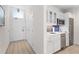 Efficient kitchenette with stainless steel appliances, white cabinets, and a stylish backsplash at 225 Sands Point Rd # 6204, Longboat Key, FL 34228