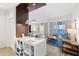 Inviting living area featuring elegant decor, a dining area, and access to a private balcony with water views at 225 Sands Point Rd # 6204, Longboat Key, FL 34228