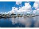 Picturesque marina view with numerous boats docked under a bright blue sky with fluffy white clouds at 225 Sands Point Rd # 6204, Longboat Key, FL 34228