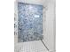 Beautiful walk-in shower with stunning blue herringbone tile and glass enclosure at 225 Sands Point Rd # 6204, Longboat Key, FL 34228