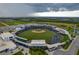 Panoramic aerial view of the stadium, showing the field, seating, parking, and surrounding landscape at 23189 Banbury Way # 203, Venice, FL 34293