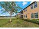 Serene backyard featuring a screen-in porch overlooking water and lush landscaping at 23189 Banbury Way # 203, Venice, FL 34293