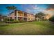 Enjoy the outdoors from this backyard view, complete with a screened-in porch and lush green grass at 23189 Banbury Way # 203, Venice, FL 34293