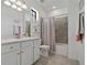 Bright bathroom features a shower/bath tub combo with a colorful curtain at 23189 Banbury Way # 203, Venice, FL 34293