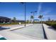 A community bocce ball court surrounded by tropical landscaping at 23189 Banbury Way # 203, Venice, FL 34293