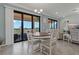 Bright dining area with access to the balcony and features a modern chandelier at 23189 Banbury Way # 203, Venice, FL 34293