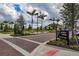 Brick paved street lined with palm trees and the 'Downtown Wellen Park' sign at 23189 Banbury Way # 203, Venice, FL 34293