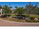 The Sarasota National entrance sign is surrounded by lush landscaping and a beautiful brick entranceway at 23189 Banbury Way # 203, Venice, FL 34293