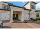 Townhome exterior featuring attached garages and inviting entrances with well-maintained landscaping at 23189 Banbury Way # 203, Venice, FL 34293
