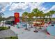 Lively outdoor food truck area with palm trees, tables, and a variety of dining options for a relaxed atmosphere at 23189 Banbury Way # 203, Venice, FL 34293