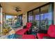Spacious screened lanai with comfortable seating and pleasant view through large windows at 23189 Banbury Way # 203, Venice, FL 34293