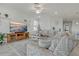 Cozy living room with plush seating, a modern television, and neutral decor at 23189 Banbury Way # 203, Venice, FL 34293