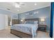 Serene main bedroom with blue walls, wood furniture, and an en-suite bathroom at 23189 Banbury Way # 203, Venice, FL 34293