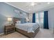 Calming main bedroom with a plush bed, decorative lamps, and natural light from the window at 23189 Banbury Way # 203, Venice, FL 34293