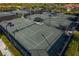 A view of a community tennis court with shaded seating area for players at 23189 Banbury Way # 203, Venice, FL 34293