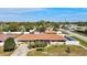 Aerial view of a single-story home with a well-manicured lawn and surrounding neighborhood at 2347 Sunnyside Pl, Sarasota, FL 34239
