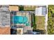 Aerial view of a screened-in pool and spa, surrounded by a well-maintained backyard at 2347 Sunnyside Pl, Sarasota, FL 34239