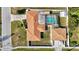 A sunny aerial view of a well-maintained property with a screened pool and fully fenced yard at 2347 Sunnyside Pl, Sarasota, FL 34239