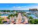 Scenic aerial view of a marina with yachts, palm trees, and waterfront property on a clear, sunny day at 2347 Sunnyside Pl, Sarasota, FL 34239