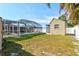 A full view of the backyard featuring a screened-in pool and a cabana at 2347 Sunnyside Pl, Sarasota, FL 34239