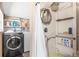 Bathroom featuring a shower, washer, dryer, and storage shelves at 2347 Sunnyside Pl, Sarasota, FL 34239