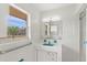 Well-lit bathroom with a turquoise sink and white tile, offering a clean and classic aesthetic at 2347 Sunnyside Pl, Sarasota, FL 34239