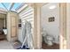 Bathroom featuring a toilet, sink, mirror, and a built in storage cabinet at 2347 Sunnyside Pl, Sarasota, FL 34239