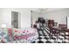 Bedroom featuring black and white checkerboard floors, quilt on bed, ceiling fan, and multiple entrances at 2347 Sunnyside Pl, Sarasota, FL 34239