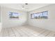 Bright bedroom featuring tile flooring and multiple windows allowing natural light at 2347 Sunnyside Pl, Sarasota, FL 34239