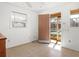 Bedroom with tile floors, light from windows, and door to screened-in lanai at 2347 Sunnyside Pl, Sarasota, FL 34239