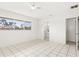 Bright bedroom featuring tile floors, a ceiling fan, and a large window offering a neighborhood view at 2347 Sunnyside Pl, Sarasota, FL 34239