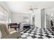 Large bedroom with black and white checkerboard floors, ceiling fan, desk, and TV at 2347 Sunnyside Pl, Sarasota, FL 34239