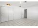 Spacious bedroom with tile floors, closet, and door leading to bathroom at 2347 Sunnyside Pl, Sarasota, FL 34239