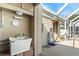 Exterior of home featuring a utility sink, covered area and access to the backyard at 2347 Sunnyside Pl, Sarasota, FL 34239