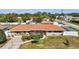 Well-maintained single-story home with lush green lawn and mature landscaping at 2347 Sunnyside Pl, Sarasota, FL 34239