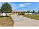 One story home featuring a spacious front lawn, mature tree, and long driveway at 2347 Sunnyside Pl, Sarasota, FL 34239