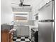 Bright kitchen with stainless steel refrigerator, and sleek black and white checkered flooring at 2347 Sunnyside Pl, Sarasota, FL 34239