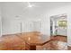 Spacious living room with terracotta tile flooring and an open floor plan leading to the modern kitchen at 2347 Sunnyside Pl, Sarasota, FL 34239