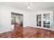 Inviting living room with beautiful tile floors and french doors opening to an enclosed porch at 2347 Sunnyside Pl, Sarasota, FL 34239