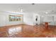 Spacious, bright living room featuring tiled floors and ceiling fans at 2347 Sunnyside Pl, Sarasota, FL 34239