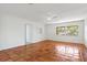 Spacious living room with terracotta tile flooring, a ceiling fan, and a window with a view of the outdoors at 2347 Sunnyside Pl, Sarasota, FL 34239